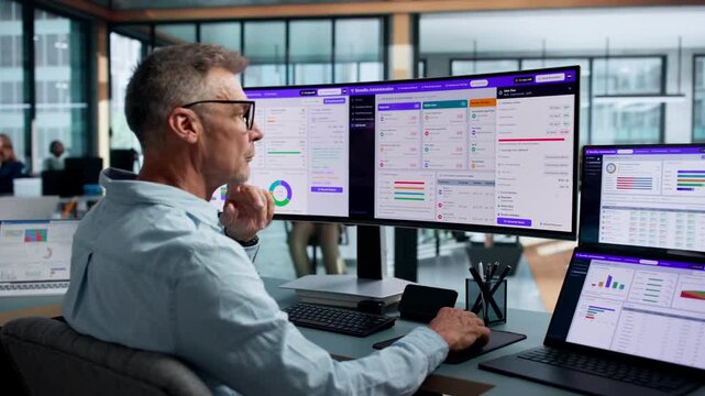 HR Manager Reviewing Employee Benefits On Dual Touchscreen Laptop