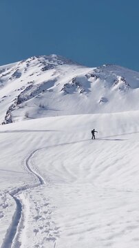 Panning shot of ski tourer ascending Gurpitscheck mountain, Lungau, Salzburg Land, Austria