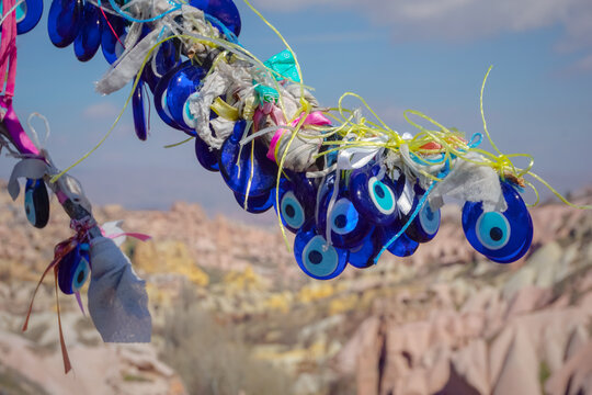 Traditional evil eye amulets hanging on tree branch in Cappadocia