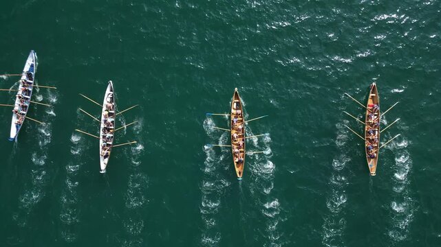 Torbay, South Devon, England: DRONE VIEWS: An anonymous, overhead view of gig rowing crews training at sea. Torbay is a magnet for water sport enthusiasts including rowing and sailing clubs.