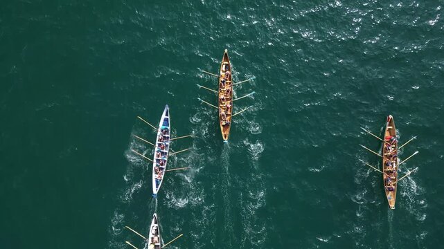 Torbay, South Devon, England: DRONE VIEWS: An anonymous, overhead view of gig rowing crews training at sea. Torbay is a magnet for water sport enthusiasts including rowing and sailing clubs.