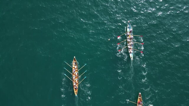 Torbay, South Devon, England: DRONE VIEWS: An anonymous, overhead view of gig rowing crews training at sea. Torbay is a magnet for water sport enthusiasts including rowing and sailing clubs.