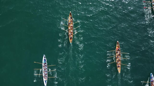 Torbay, South Devon, England: DRONE VIEWS: An anonymous, overhead view of gig rowing crews training at sea. Torbay is a magnet for water sport enthusiasts including rowing and sailing clubs.