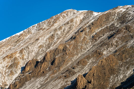 Fresh snow dusts Yukhin Peak's southern slopes near Lenin Peak Camp 1 in  August