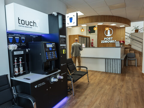 Gdansk, Poland - Jule 14, 2026: Modern office waiting area featuring in a private hospital an automated coffee station and reception desk, highlighting professional interior design and convenience