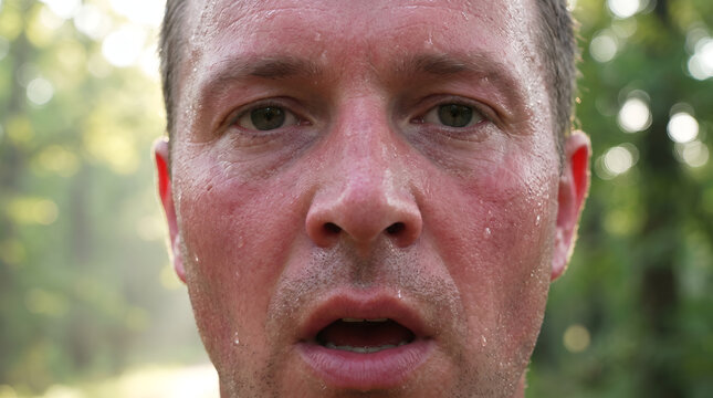 Close up portrait of surprised man face looking directly into camera