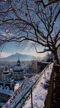 Salzburg winter view with snowfall looking over Nonntal and Untersberg mountain from Stift Nonntal at sunset, Salzburg Land, Austria