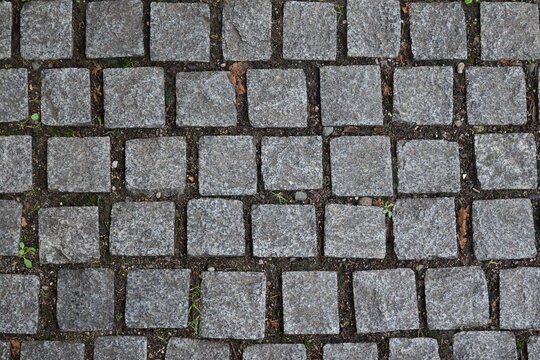 Grey cobblestone paving pattern creating urban texture