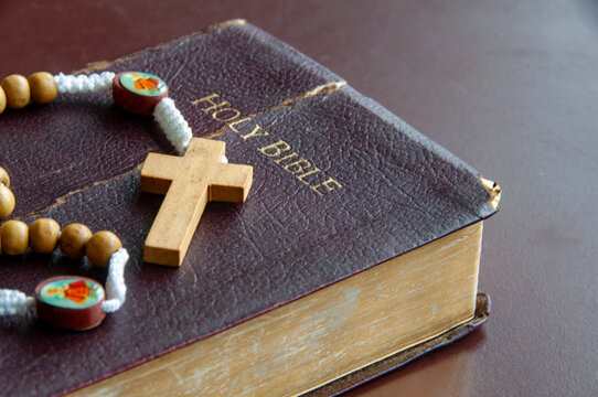 Holy Rosary on top of Holy Bible with customizable space for text or religious ideas.