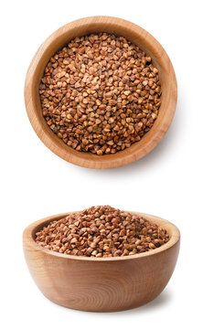 Set of buckwheat groats in a wooden bowl on a white. Isolated