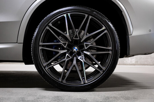 New BMW X5 M in matte gray, exterior view inside a private covered parking garage, aggressive premium SUV design, sporty styling, dramatic lighting, luxury performance vehicle, modern automotive photo