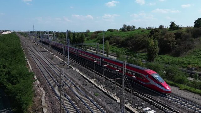 Europe, Italy , Milan - Frecciarossa Hight speed 300km h train railway from Milan  to Rome view from the drone - the faster way to travel in Italy for tourist and passengers - tourist destination 