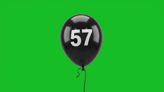 Black balloon with number 57 floating on green screen