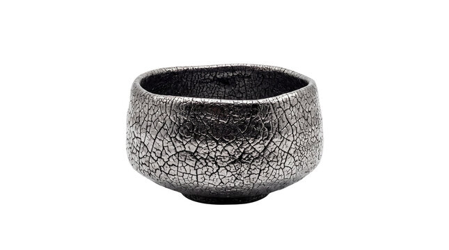 Handmade raku ceramic tea bowl with metallic crackle glaze, traditional Japanese chawan for matcha tea ceremony, rustic pottery vessel isolated PNG with Transparent Background