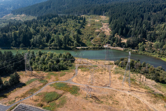 4K aerial drone view of high voltage transmission towers at Bradford Island area carrying hydroelectric power from Bonneville Dam across Columbia River toward Washington, Oregon, USA, electrical grid