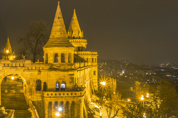 A captivating night view of the brilliantly illuminated Fisherman's Bastion turrets and stone ramparts glowing against the Budapest skyline. © Bill Lezos