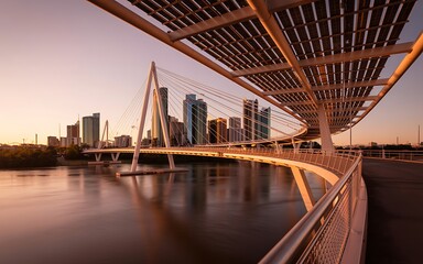 Fototapeta premium Modern Pedestrian Suspension Bridge City Skyline Sunset Reflection Landscape Photo
