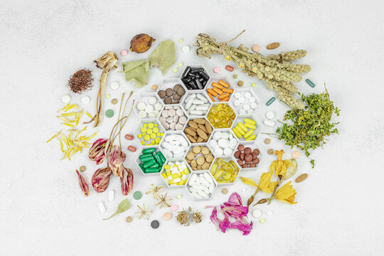 Natural remedies and alternative medicine concept. Various pills and capsules in a hexagonal tray