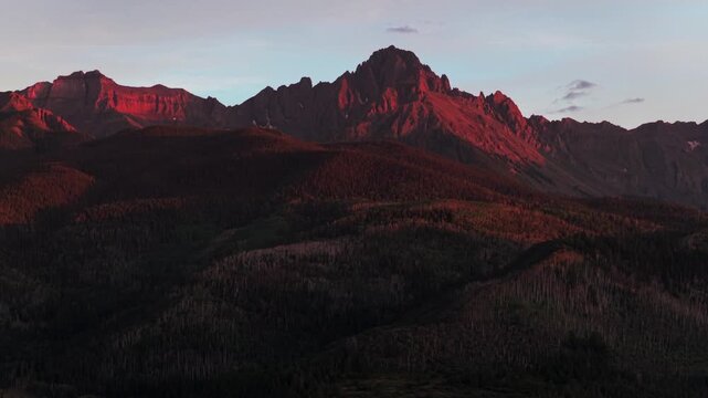 Mount Sneffels Wilderness golden hour sunset 14er prominent peak San Juan Mountain Range Town of Ridgway Ouray Colorado aerial drone nature landscape summer clouds alpenglow Ouray County upwards