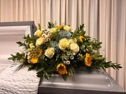 yellow sunflower funeral flower arrangement