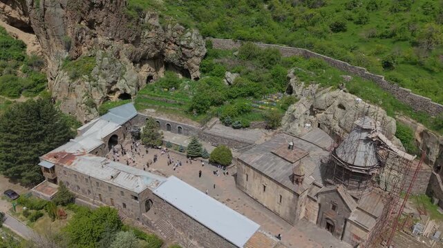 Aerial view complex of Geghard, Kotayk region, Armenia. Crosses in the rock, in the monastery of Geghard. Most touristic place in Armenia. The ancient Geghard Monastery in the mountains of Armenia.