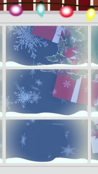Animation of view of snowflakes falling over christmas decorations from decorated window frame