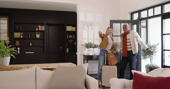 African American couple opening door entering room pulling cases and backpack settling, copy space