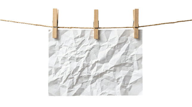 White crumpled paper sheet hanging from a sturdy brown rope using three classic wooden clothespins to hold it on transparent background