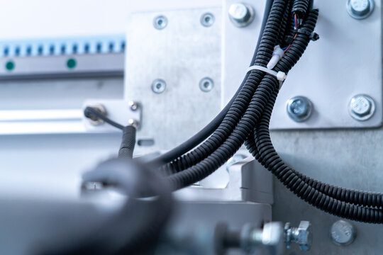 Electrical cables and machinery components on industrial production line