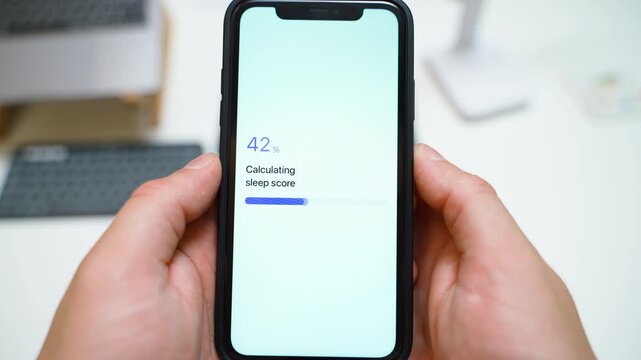 Sleep score calculating on smartphone screen completes with final result