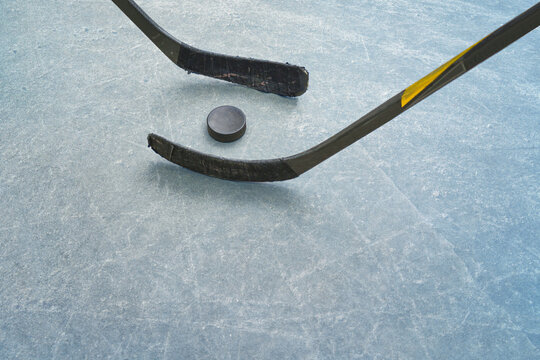  Ice hockey players on the ice hockey arena.  An ice surface as an ice rink with ice skates tracks.