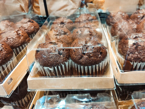Chocolate muffins on display in bakery shop