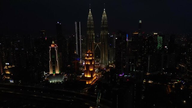 KL city skyline with illuminated Twin Towers at night Perfect aerial view drone