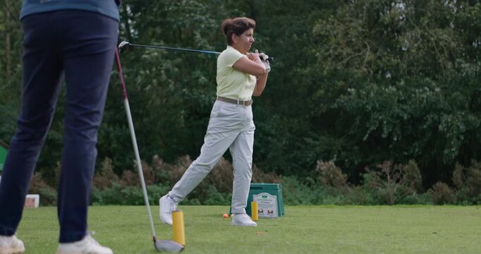 Woman, stroke and driver for golf, sports and competition on grass, challenge and tournament. Female person, athlete and ready for game, practice and hobby or recreation, action and equipment at club