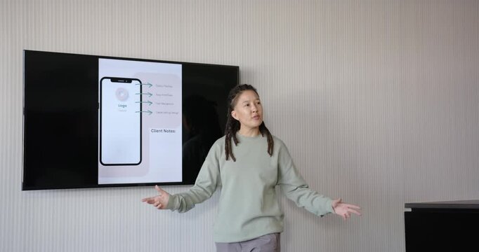 Nonbinary speaker reacting to Client Notes screen, speaking in meeting room, explaining details