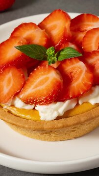 Dessert with fresh strawberries on a tart served on a white plate