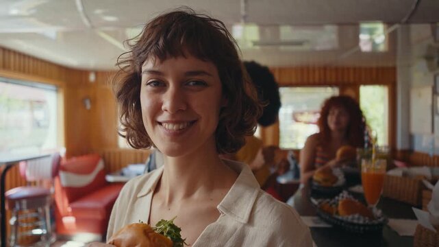 Cinematic footage about a group of multi-ethnic friends eating and having fun in an american styled diner restaurant.