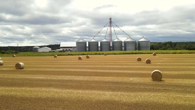 Low altitude drone flight forward over hay bales in PEI, Canada
