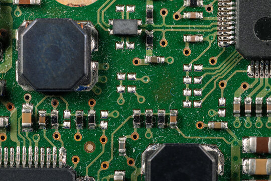 Old dusty printed circuit board with electronic components macro view