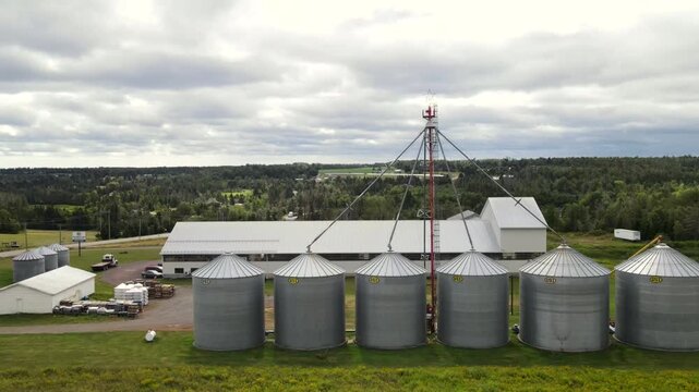 Aerial vertical reveal of modern grain silos in PEI Canada