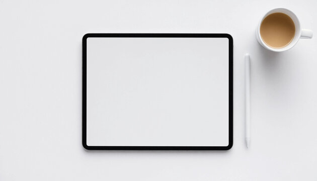 Top view of a digital tablet with blank screen and a cup of coffee on white background