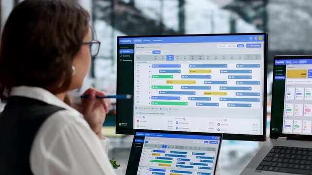 Hotel Manager Using Property Management System On Laptop