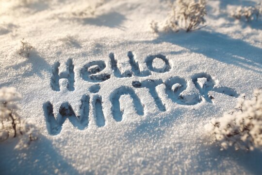 Written in the snow reads hello winter outdoors nature frosty.
