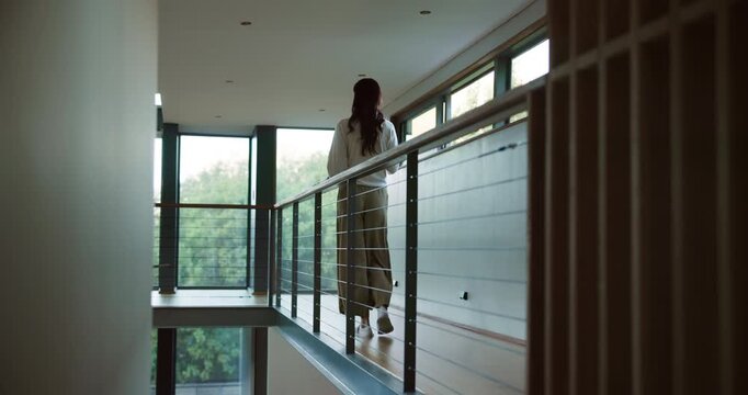 Coffee, walk and woman in home with back view, peace or calm on remote work break. Thinking, drink and person with morning beverage in house by mezzanine for thoughts, vision or reflection by window