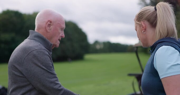 People, coaching and sports or lesson, golf and smile or positive mindset for match. Senior man, woman and conversation and discussion in outdoors, course and tournament or laughing for competition
