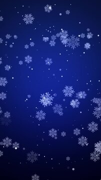 White snowflakes falling against a deep blue winter background in vertical orientation for mobile