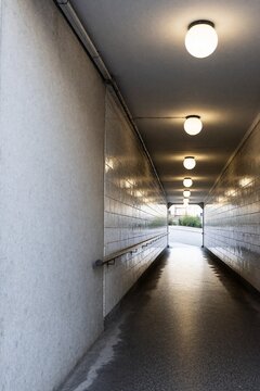 Tiled underpass corridor with round lights