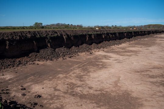 Large scale excavation and earthworks for retention basin at construction site