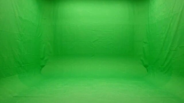 Triptych of green fabric folds in soft lighting