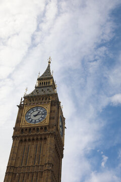 Low angle view of Elizabeth Tower and Big Ben clock against a cloudy blue sky in London